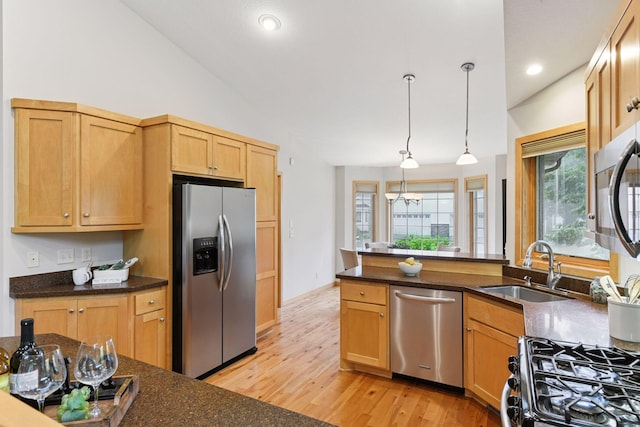 1614 Maple Manors Ct, Mound, MN 55364 - kitchen with appliances with stainless steel finishes, light wood-style flooring, decorative light fixtures, vaulted ceiling, and a peninsula