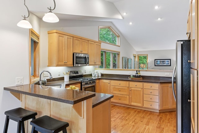 1614 Maple Manors Ct, Mound, MN 55364 - kitchen with appliances with stainless steel finishes, a peninsula, light brown cabinetry, light wood-style flooring, and high vaulted ceiling
