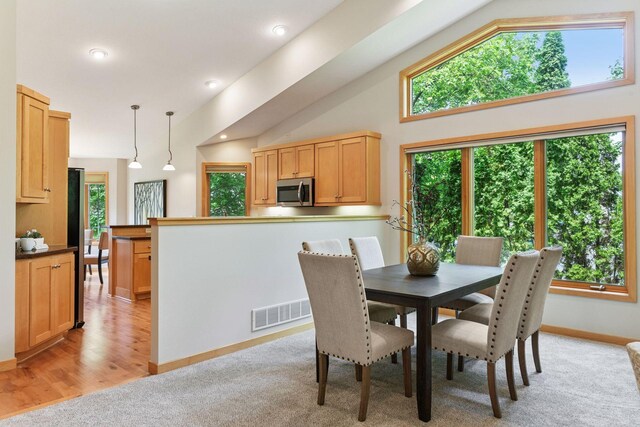 1614 Maple Manors Ct, Mound, MN 55364 - dining area featuring lofted ceiling, recessed lighting, light colored carpet, and light wood finished floors