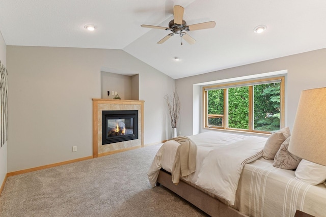 1614 Maple Manors Ct, Mound, MN 55364 - bedroom with vaulted ceiling, carpet floors, a tiled fireplace, and a ceiling fan