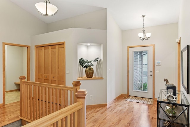 1614 Maple Manors Ct, Mound, MN 55364 - entrance foyer featuring light wood finished floors, a chandelier, and vaulted ceiling