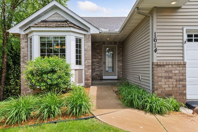 1614 Maple Manors Ct, Mound, MN 55364 - view of exterior entry with brick siding and a shingled roof
