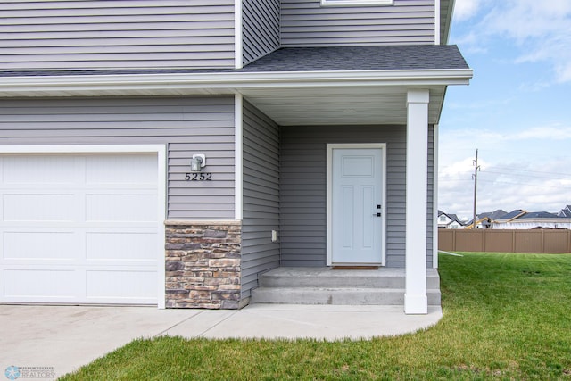 5252 8th Ct W, West Fargo, ND 58078 - view of exterior entry featuring stone siding and roof with shingles