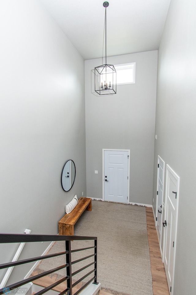 5252 8th Ct W, West Fargo, ND 58078 - foyer featuring a chandelier, a high ceiling, and light wood-type flooring