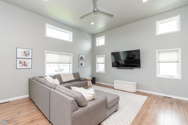 5252 8th Ct W, West Fargo, ND 58078 - living room featuring a high ceiling, recessed lighting, ceiling fan, and light wood-style flooring
