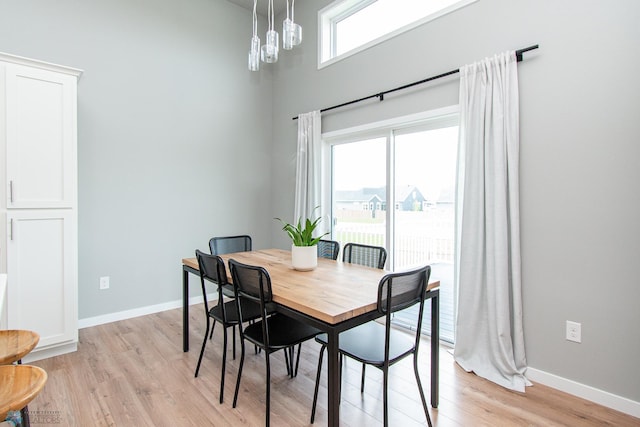 5252 8th Ct W, West Fargo, ND 58078 - dining area featuring light wood-type flooring and a towering ceiling