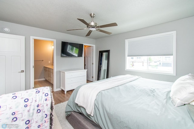 5252 8th Ct W, West Fargo, ND 58078 - bedroom with light wood finished floors, a ceiling fan, and connected bathroom