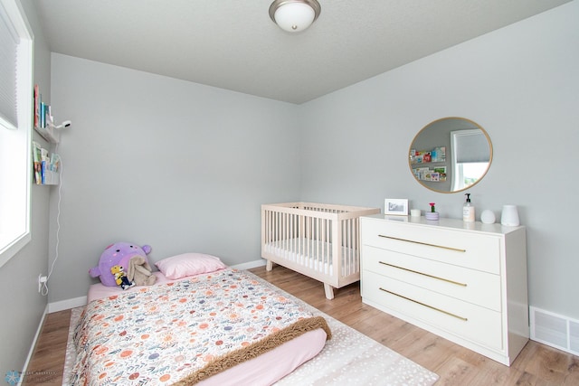 5252 8th Ct W, West Fargo, ND 58078 - bedroom featuring light wood-style flooring and baseboards
