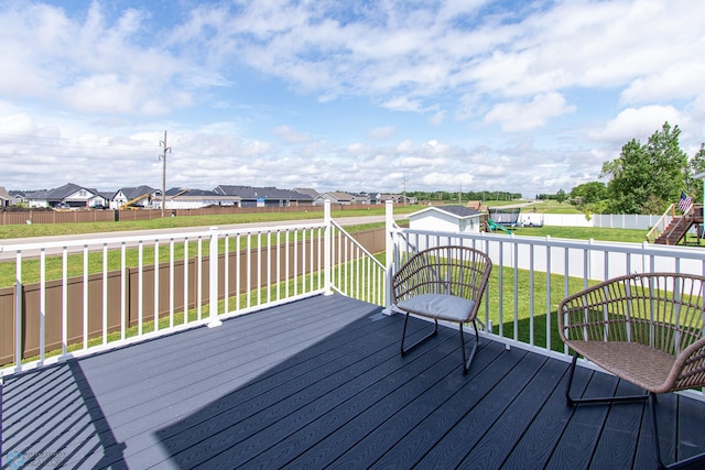 5252 8th Ct W, West Fargo, ND 58078 - wooden deck with a residential view, a fenced backyard, and a storage unit