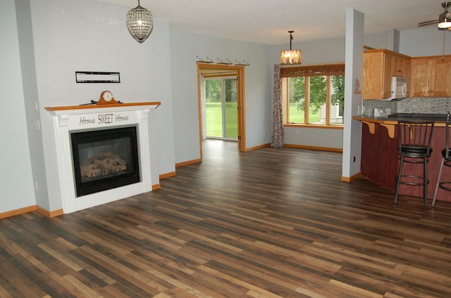 224 Goldfinch Ln, Clearwater, MN 55320 - unfurnished living room featuring a chandelier, dark wood finished floors, a glass covered fireplace, and ceiling fan