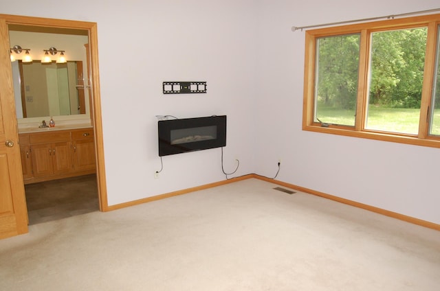 224 Goldfinch Ln, Clearwater, MN 55320 - unfurnished living room featuring light colored carpet and a glass covered fireplace