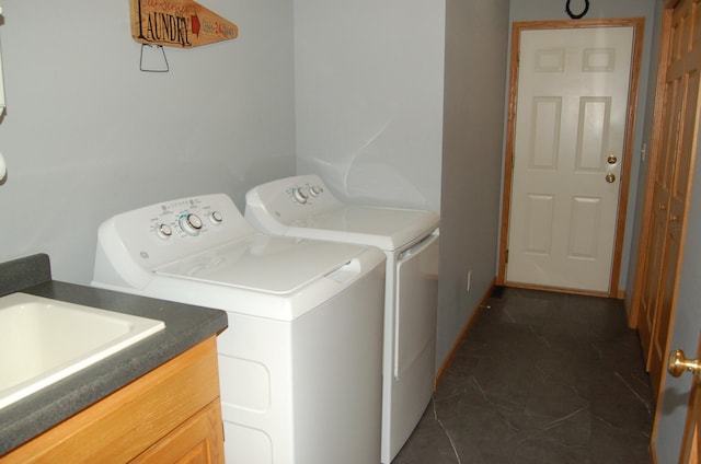 224 Goldfinch Ln, Clearwater, MN 55320 - laundry area featuring washing machine and clothes dryer, dark tile patterned flooring, and cabinet space