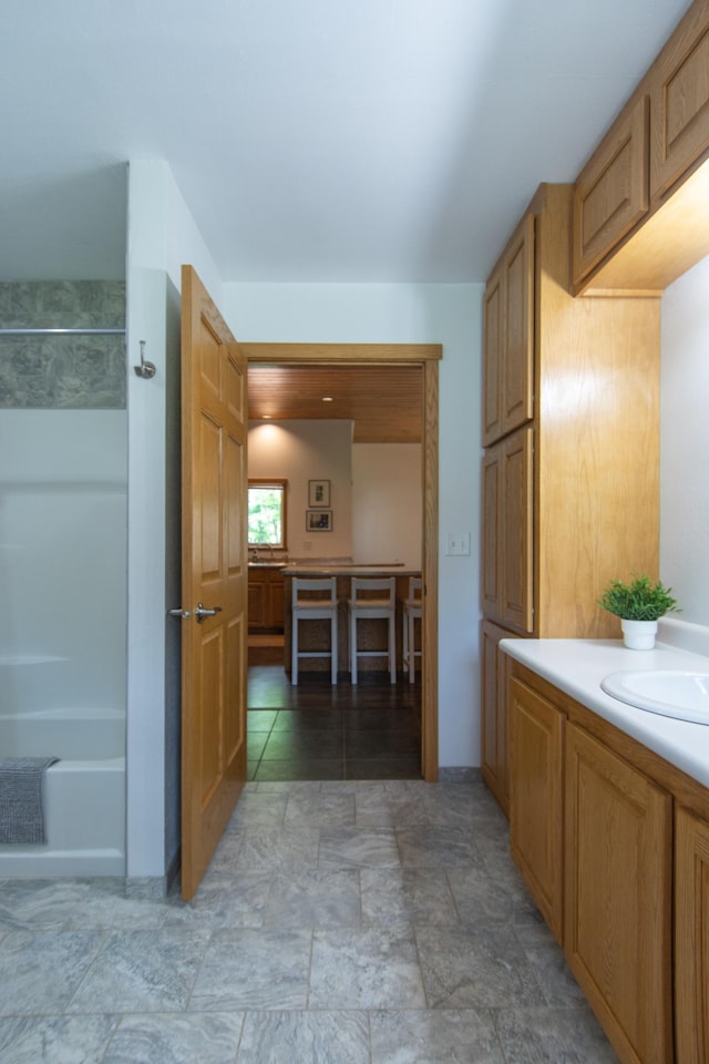 8290 Gladstone Lake Rd, Brainerd, MN 56401 - full bath with vanity, washtub / shower combination, and stone finish flooring