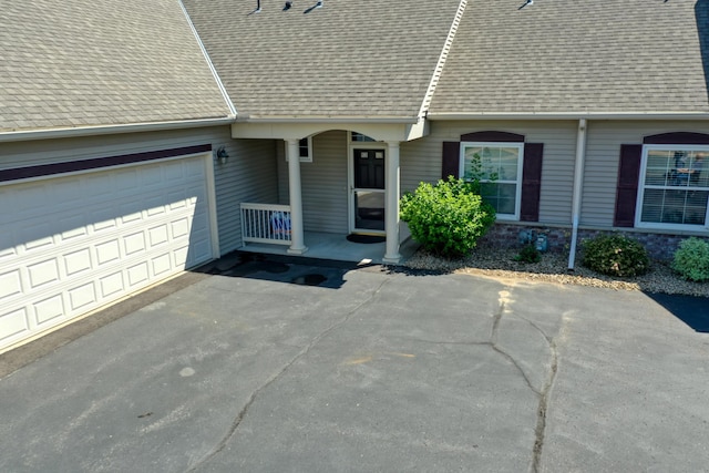 5010 384th Trl, North Branch, MN 55056 - property entrance with a shingled roof, driveway, an attached garage, and covered porch