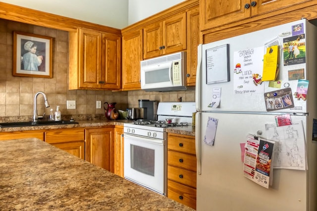 5010 384th Trl, North Branch, MN 55056 - kitchen featuring white appliances, brown cabinets, and tasteful backsplash