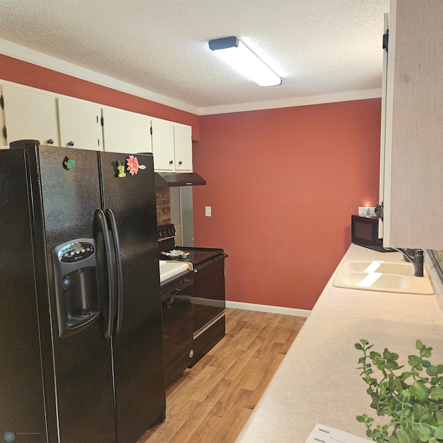 327 6th Ave, Mapleton, ND 58059 - kitchen with black appliances, under cabinet range hood, light wood-style flooring, light countertops, and a textured ceiling