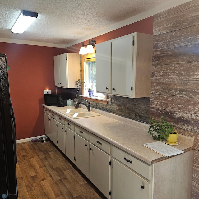 327 6th Ave, Mapleton, ND 58059 - kitchen featuring black microwave, a textured ceiling, dark wood-style floors, light countertops, and white cabinetry