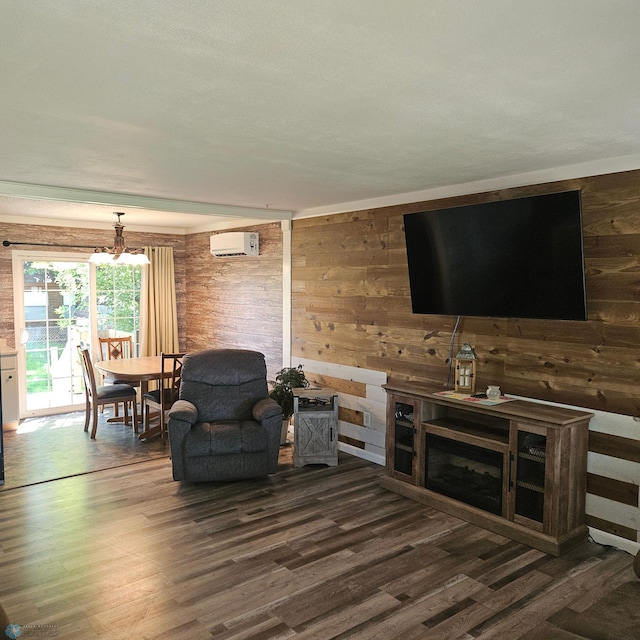 327 6th Ave, Mapleton, ND 58059 - living area featuring dark wood-style flooring, a wall mounted air conditioner, wood walls, and a chandelier