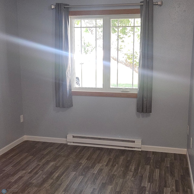 327 6th Ave, Mapleton, ND 58059 - unfurnished room featuring a baseboard radiator and dark wood finished floors