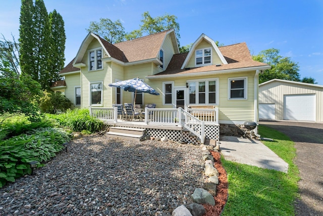 11826 State Road 48, Frederic, WI 54837 - rear view of house with an outdoor structure, a detached garage, a wooden deck, and a shingled roof