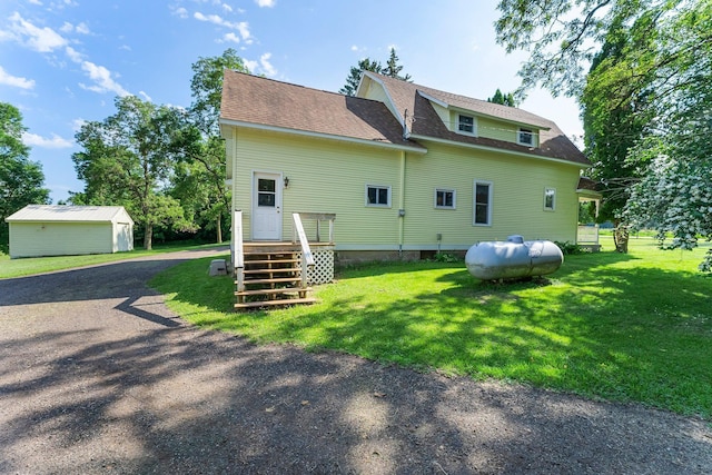 11826 State Road 48, Frederic, WI 54837 - back of property with a yard, roof with shingles, a storage shed, and dirt driveway