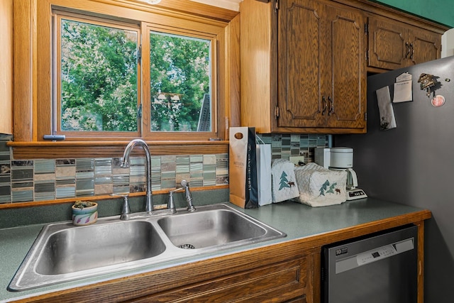 11826 State Road 48, Frederic, WI 54837 - kitchen with stainless steel dishwasher, tasteful backsplash, dark countertops, and brown cabinetry