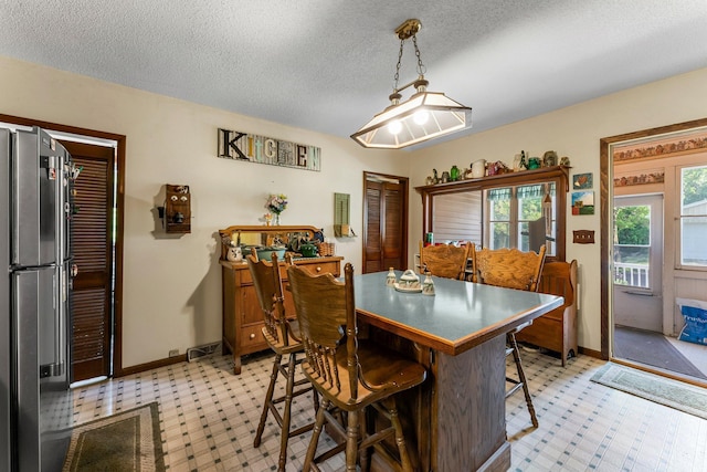 11826 State Road 48, Frederic, WI 54837 - dining space featuring a textured ceiling and light floors