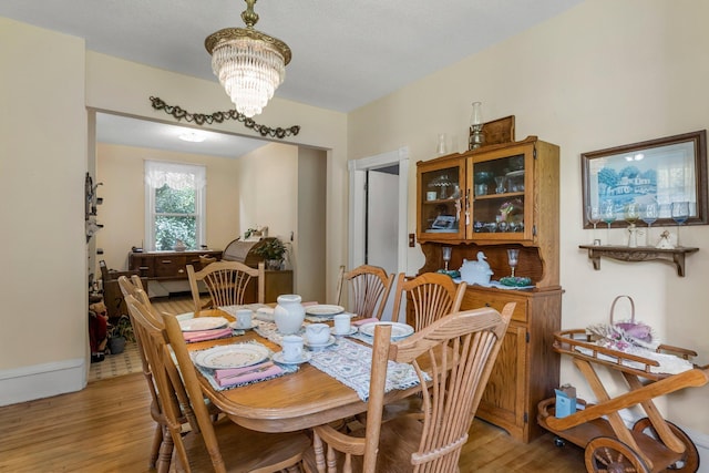 11826 State Road 48, Frederic, WI 54837 - dining space featuring light wood-type flooring and a chandelier