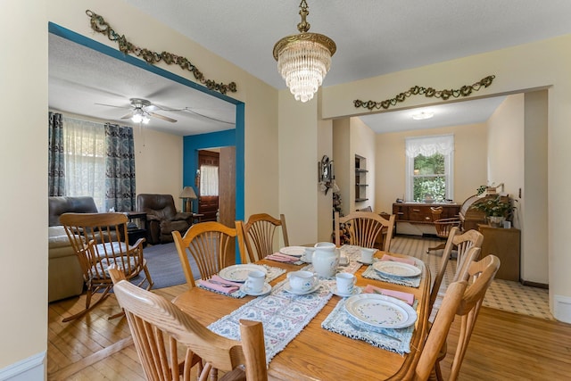 11826 State Road 48, Frederic, WI 54837 - dining area with light wood-style floors, a chandelier, a ceiling fan, and a textured ceiling