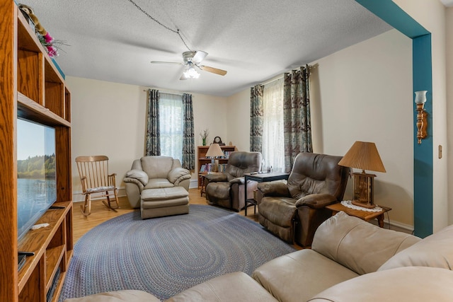 11826 State Road 48, Frederic, WI 54837 - living area featuring ceiling fan, a textured ceiling, and wood finished floors