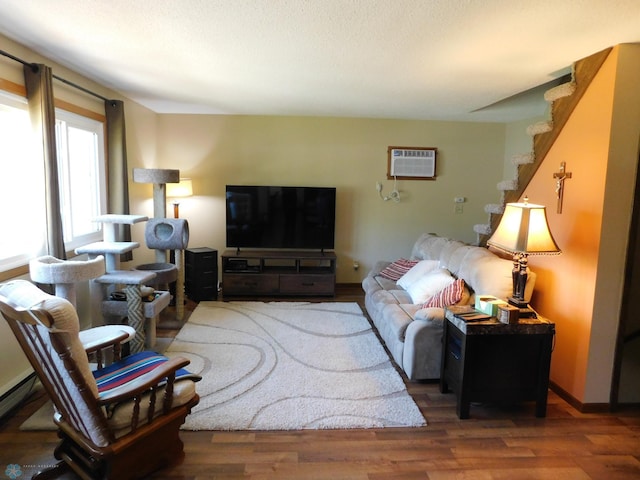 961 4th Ave W Unit B, West Fargo, ND 58078 - living room featuring a wall unit AC, wood finished floors, and stairway