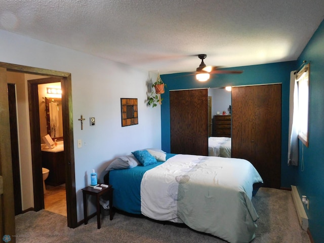 961 4th Ave W Unit B, West Fargo, ND 58078 - bedroom with carpet, a textured ceiling, a ceiling fan, and ensuite bathroom