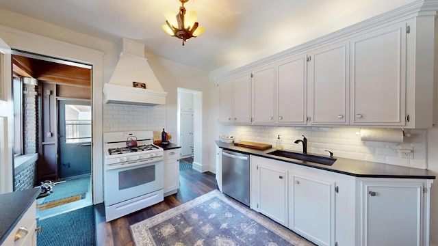 315 Fountain St, Albert Lea, MN 56007 - kitchen featuring white range with gas cooktop, stainless steel dishwasher, premium range hood, dark countertops, and white cabinets