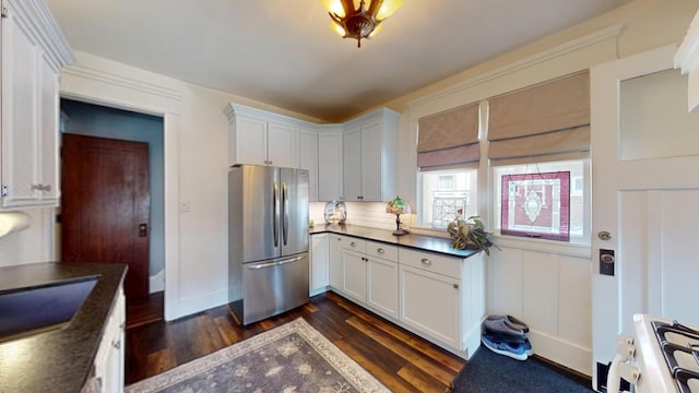 315 Fountain St, Albert Lea, MN 56007 - kitchen with freestanding refrigerator, dark countertops, dark wood-style floors, and stove