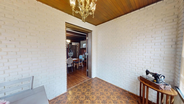 315 Fountain St, Albert Lea, MN 56007 - hallway with brick wall, a chandelier, and wood ceiling
