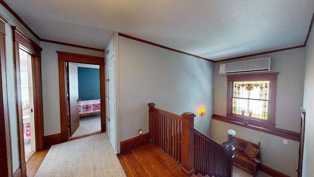 315 Fountain St, Albert Lea, MN 56007 - hallway with a wall mounted air conditioner, an upstairs landing, wood finished floors, and crown molding