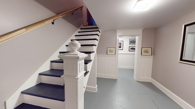 315 Fountain St, Albert Lea, MN 56007 - staircase with finished concrete flooring and a wainscoted wall