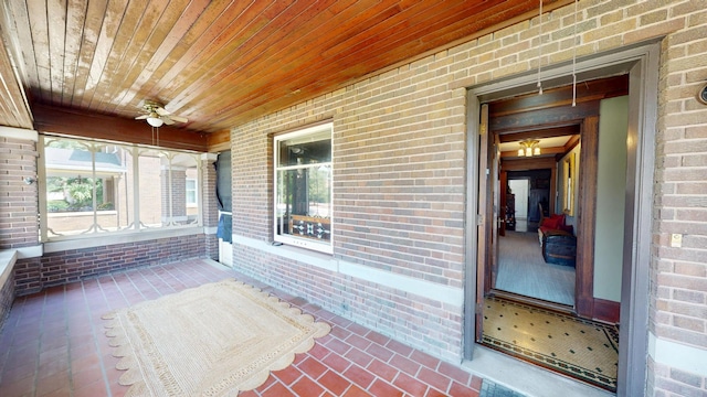 315 Fountain St, Albert Lea, MN 56007 - unfurnished sunroom featuring brick wall, brick floors, wooden ceiling, and a ceiling fan