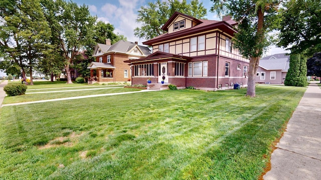 315 Fountain St, Albert Lea, MN 56007 - view of front of house with brick siding, a chimney, and a front yard