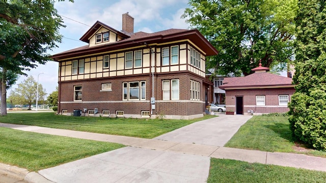 315 Fountain St, Albert Lea, MN 56007 - view of front of property with a chimney, a front yard, brick siding, and driveway