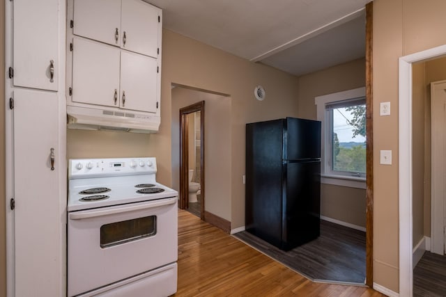 616 5th St, Mankato, MN 56001 - kitchen with white range with electric cooktop, freestanding refrigerator, under cabinet range hood, and white cabinetry