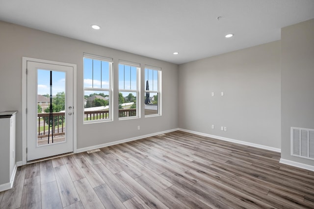 15484 Eames Way, Apple Valley, MN 55124 - empty room with plenty of natural light, wood finished floors, recessed lighting, and a pendent fire sprinkler
