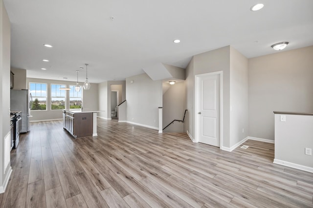 15484 Eames Way, Apple Valley, MN 55124 - unfurnished living room featuring light wood finished floors and recessed lighting