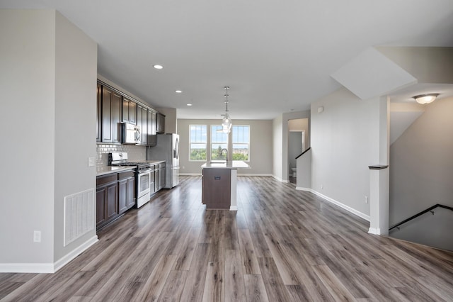 15484 Eames Way, Apple Valley, MN 55124 - kitchen featuring stainless steel appliances, dark brown cabinets, wood finished floors, light countertops, and recessed lighting