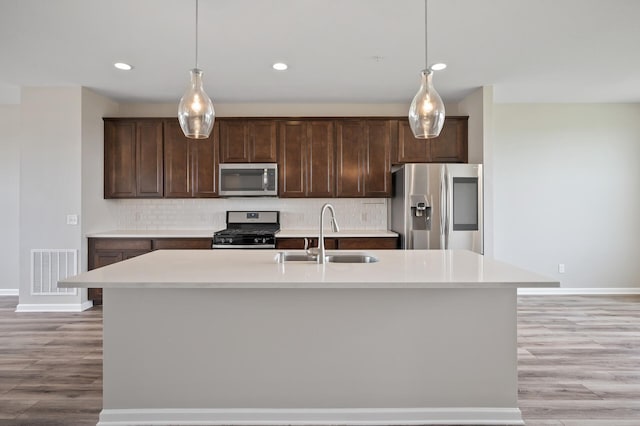 15484 Eames Way, Apple Valley, MN 55124 - kitchen with stainless steel appliances, backsplash, dark brown cabinetry, and recessed lighting