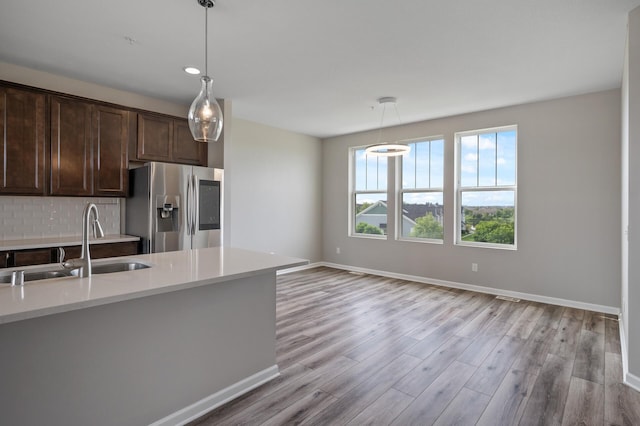 15484 Eames Way, Apple Valley, MN 55124 - kitchen featuring stainless steel refrigerator with ice dispenser, dark brown cabinetry, light wood-style floors, and hanging light fixtures