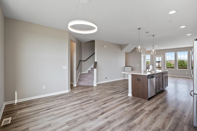 15484 Eames Way, Apple Valley, MN 55124 - kitchen featuring open floor plan, appliances with stainless steel finishes, light wood-style flooring, recessed lighting, and light countertops