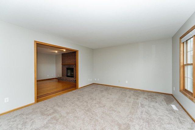 2319 Viola View Ln NE, Rochester, MN 55906 - unfurnished living room featuring carpet, plenty of natural light, and a brick fireplace