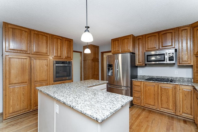 2319 Viola View Ln NE, Rochester, MN 55906 - kitchen with stainless steel appliances, light wood-style flooring, a kitchen island, light stone counters, and brown cabinets