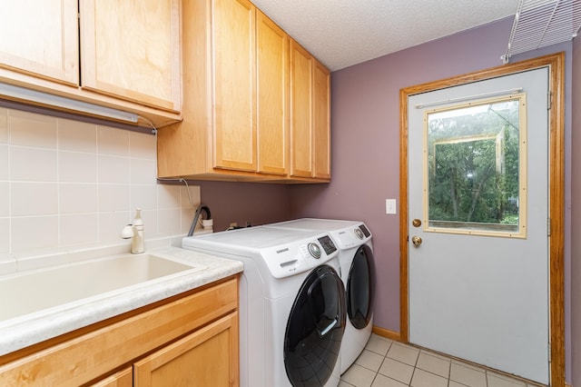 2319 Viola View Ln NE, Rochester, MN 55906 - washroom featuring cabinet space, washer and dryer, light tile patterned floors, and a textured ceiling